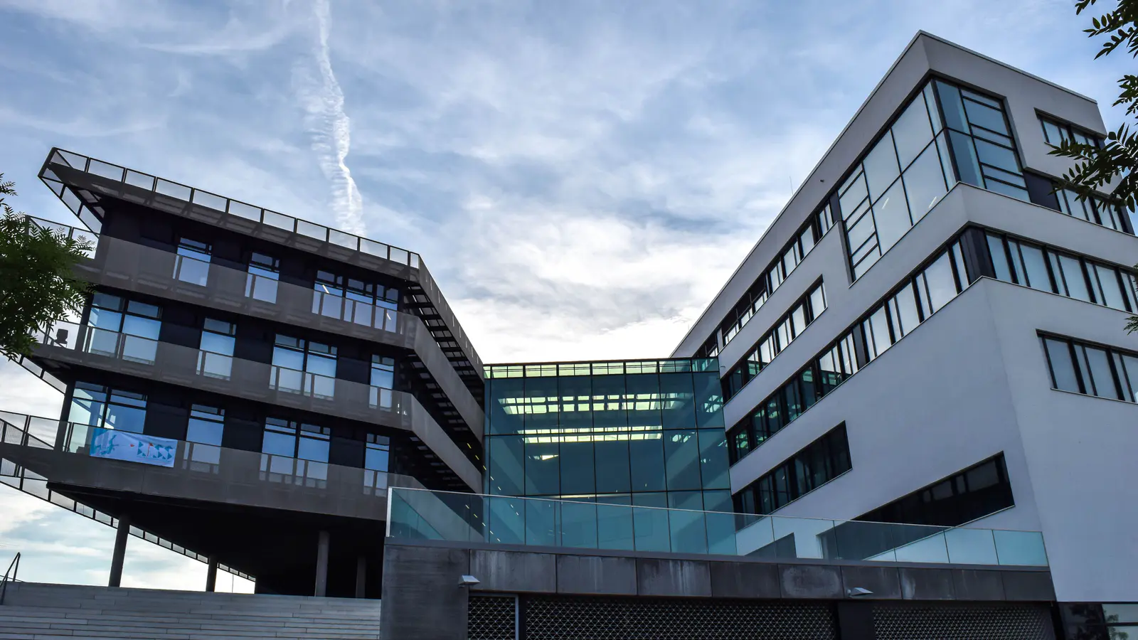 Modern school campus buildings with wide glazed classroom floors and open walkways